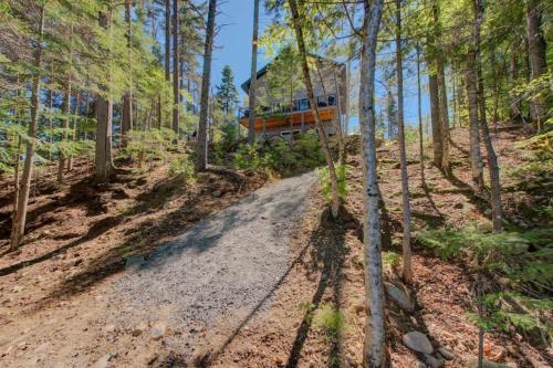 a tree house on a dirt road in the woods at Luft Skift Spa - Waterfront & Private Spa in Lac-aux-Sables