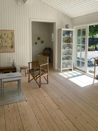 a living room with a couch and a table at Holiday Home By Nyrup Bay And Rørvig Harbour in Rørvig