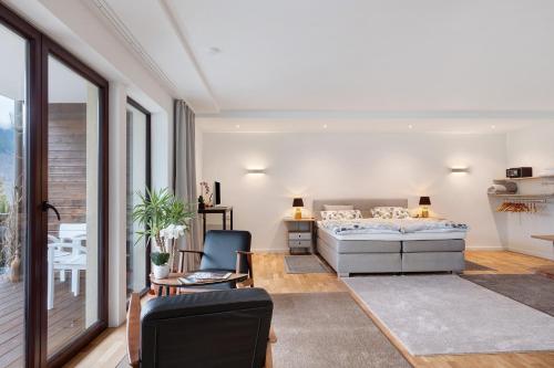 a bedroom with a bed and a couch and a table at Sonnige Ferienwohnung im Kinzigtal in Wolfach