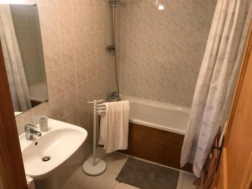 a bathroom with a sink and a tub and a shower at Gite La Lède in Bias