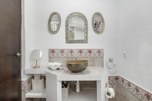 a bathroom with a sink and a bowl on a counter at El Puente Ronda in Ronda