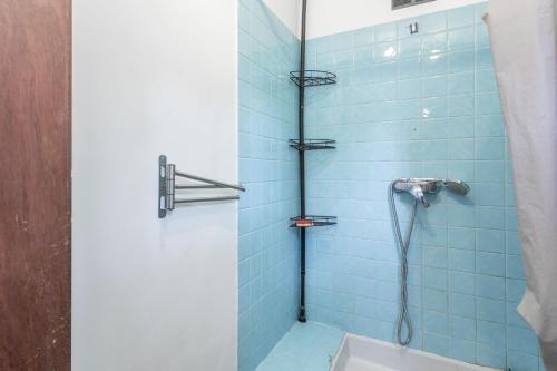 a bathroom with a shower with blue tiles at Chez Lina - studio avec terrasse in Le Lavandou