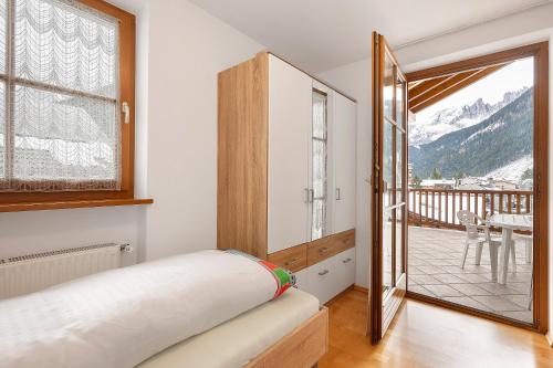 a bedroom with a bed and a balcony at Apartment Weber in Nova Levante