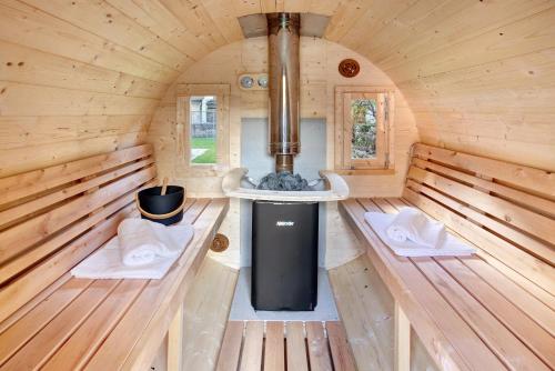 an inside view of a wooden cabin with a stove at Casa Clus Bormio apartments 1 in Valdisotto