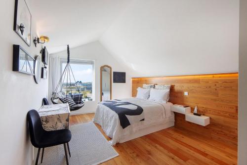 a bedroom with a large bed and a window at Salina Ria Studio in Aveiro