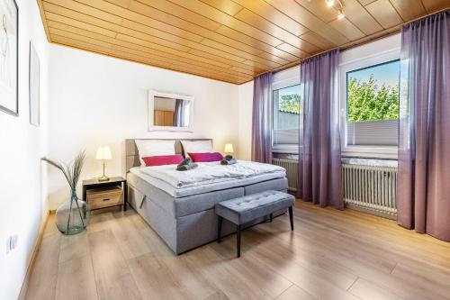 a bedroom with a bed and two windows at Fewo Mama Mia in Menden