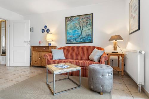 a living room with a couch and a table at Deichblick in Böhl