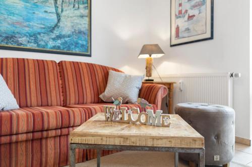 a living room with a couch and a coffee table at Deichblick in Böhl