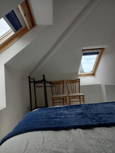 a bedroom with a bed and two chairs at Townhouse in Castleisland