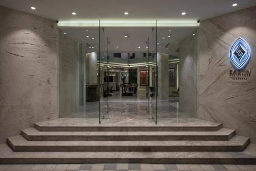 a lobby of a building with stairs and a sign at Eastin Residences Vadodara in Vadodara