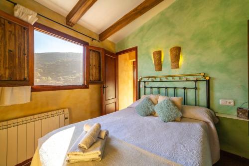 a bedroom with a large bed with a window at El Mirador in Laroya