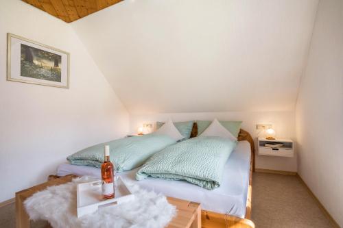 a bedroom with a bed with two pillows and a table at Jorchenhof in Hofstetten