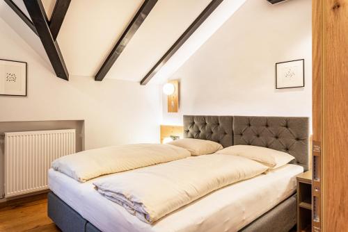 a large bed in a room with white walls at Residence Skutial App Santner in Castelrotto