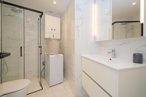 a bathroom with a toilet and a sink and a shower at Costabella Altea in Altea