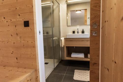 a bathroom with a shower and a sink at Kieserhof Apartment Berg in Terento