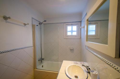 a bathroom with a sink and a shower at Villa Bini Andu in Binibeca