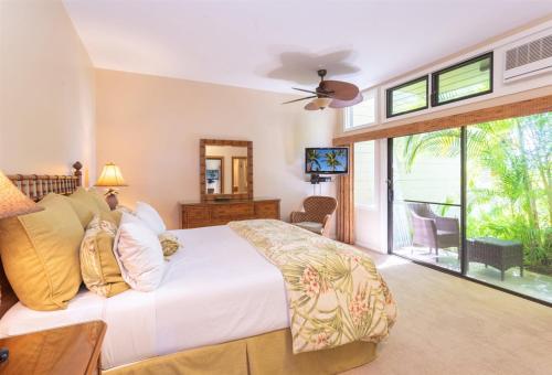 a bedroom with a white bed and a large window at 2914 Ridge in Kahana