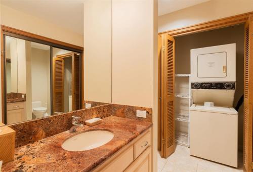a bathroom with a sink and a washer and dryer at 2914 Ridge in Kahana