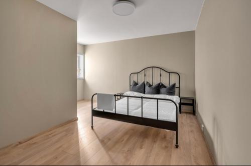 a bedroom with a metal bed in a room at Sunny Central in Kristiansand