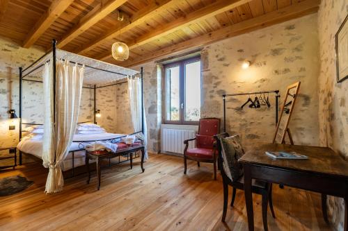 a bedroom with a bed and a desk and a table at Le Basque - Bazas in Bazas