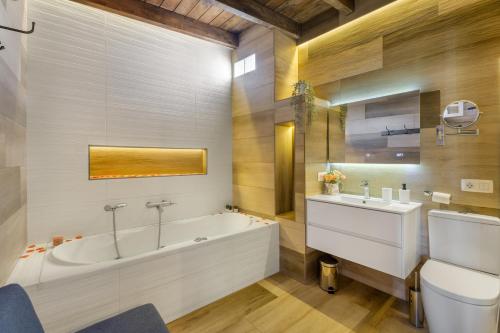 a bathroom with a tub and a sink and a toilet at Casa Miranda 2 in Araya