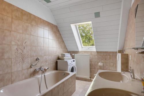 a bathroom with a tub and a sink at Wein- Und Obstbau Rupp in Obersulm
