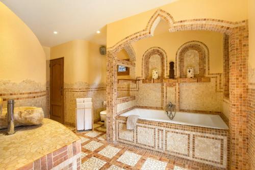a bathroom with a large tub in a room at Casa Anakena in Guía de Isora