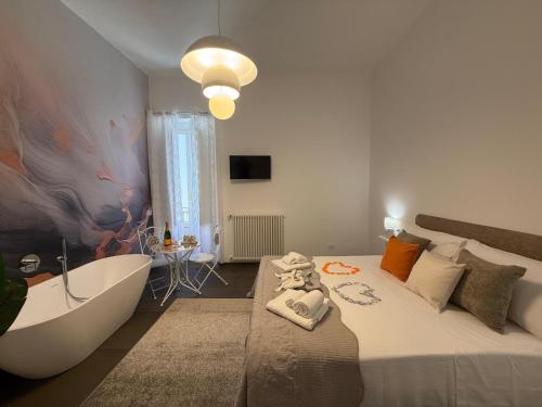 a bedroom with a large bed and a bath tub at Dimora Perrini in Fasano