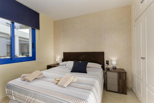 a bedroom with a large bed with towels on it at El Hacho in Manilva