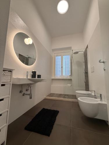a bathroom with a sink toilet and a mirror at Dimora Perrini in Fasano