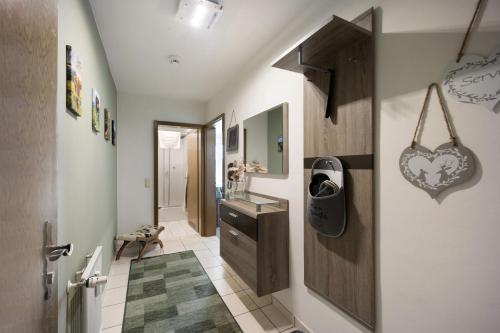 a bathroom with a heart sign on the wall at Landliebe – Seenähe & Grüntenblick in Petersthal