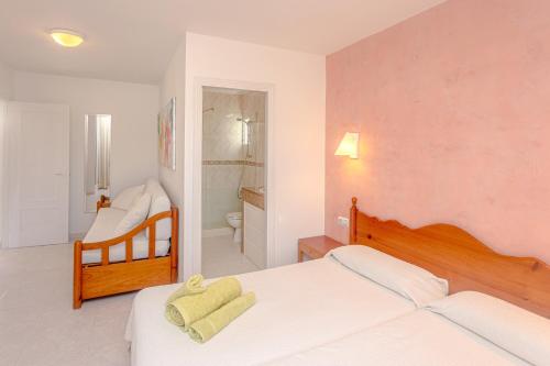 a bedroom with two beds and a bathroom at Apartamento Cala en Forcat 34 in Cala en Blanes