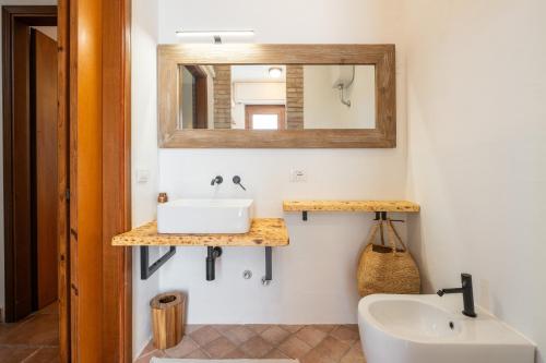 a bathroom with a sink and a mirror at Nuràya in Sarroch