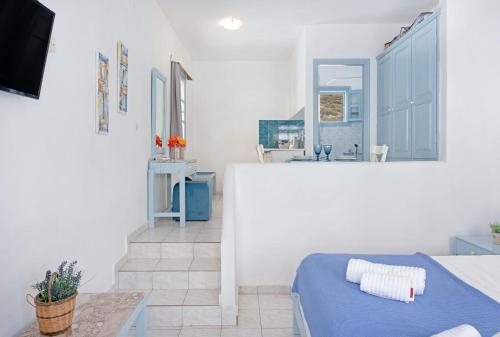 a white room with a bed and a sink at Pico Bello Patmos 14 in Patmos