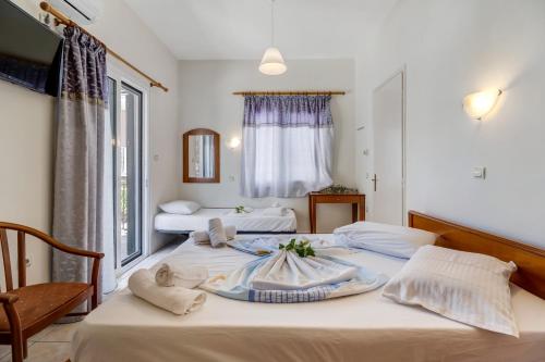 a bedroom with two beds with towels on them at Nikiana Club - Studio 6 in Nikiana