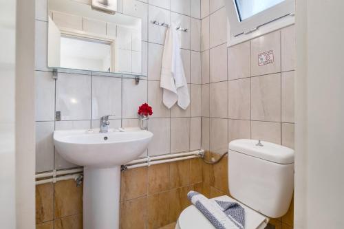 a white bathroom with a sink and a toilet at Nikiana Club - Studio 6 in Nikiana