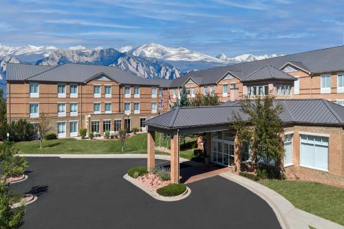 a rendering of a hotel with mountains in the background at Hilton Garden Inn Colorado Springs North Air Force Academy in Colorado Springs
