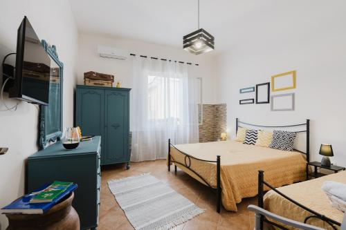 a bedroom with a bed and a table in a room at Casa Petros in Marsala