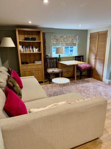 a living room with a couch and a table at The Grannery in Wadhurst