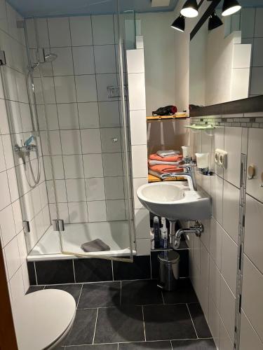 a bathroom with a glass shower and a sink at Ferienwohnung Filser in Unterammergau