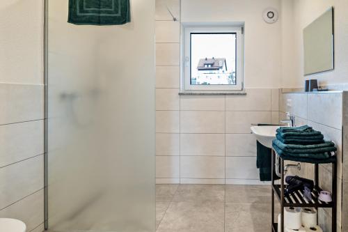 a bathroom with a shower and a sink at Tanne in Ravensburg
