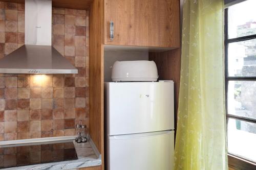 a kitchen with a white refrigerator in a room at los diablitos 3c - Ideal familias in San Juan de la Rambla