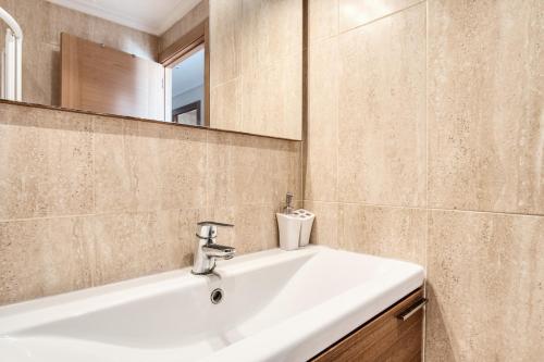 a bathroom with a white sink and a mirror at Sunflower Puerto Rico in Santa Pola