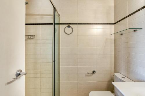 a bathroom with a glass shower with a toilet at Marinada in L'Escala