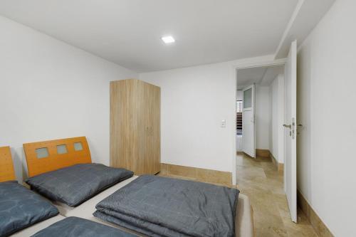 a bedroom with two beds and an open door at Ferienwohnung Tiefer Garten in Itzehoe
