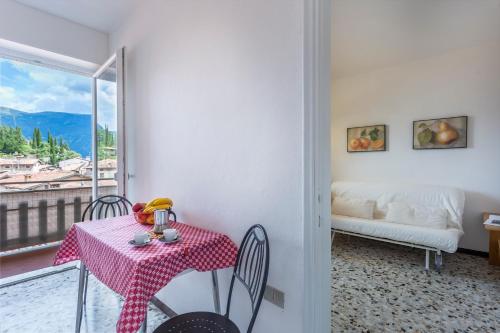 a dining room with a table and chairs and a balcony at Liver 202 in Tremosine Sul Garda