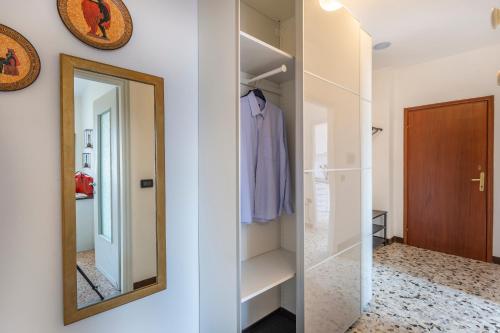 a dressing room with a mirror and a closet at Liver 202 in Tremosine Sul Garda