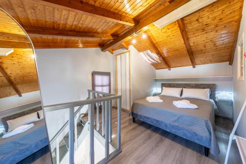 a bedroom with a bed in a room with wooden ceilings at Kate House in Ágios Matthaíos