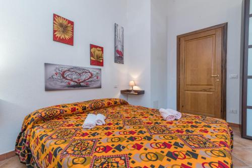 a bedroom with a bed with a colorful bedspread at Home Residence Barbara in San Teodoro