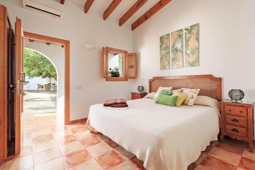 a bedroom with a bed and an open door at Boutique Hideaway Cortijo El Sarmiento - Adults Only in Mojácar